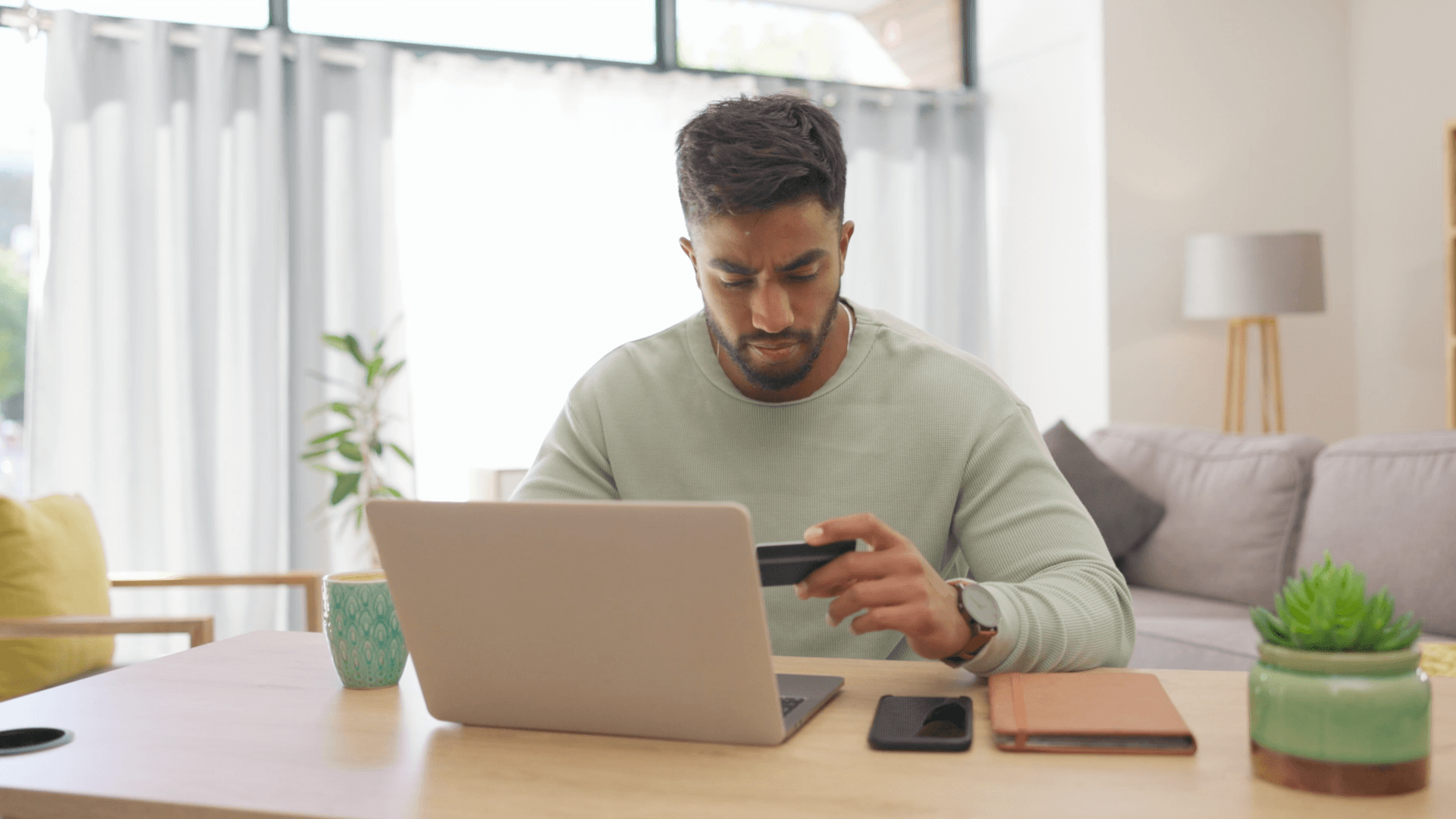 Usuário realizando pagamento com cartão no notebook